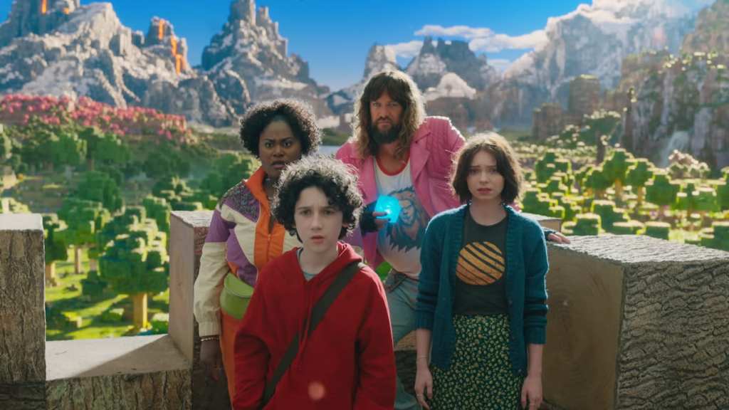Four characters standing together on a roof in Minecraft in A Minecraft Movie. 